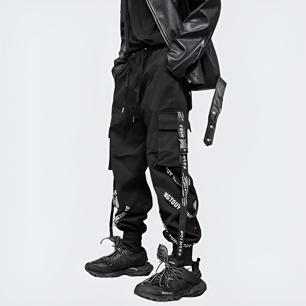 Man wearing black techwear cargo pants drawstring closure left side