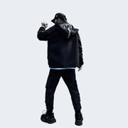 Man wearing black bybb dark jacket hooded