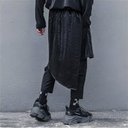 Man wearing black ninja harem pants elastic waist back view
