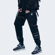 Man wearing black baggy techwear pants front side view