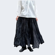 Woman wearing long black pleated skirt
