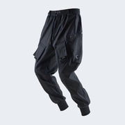 Black techwear trousers with a futuristic and technical aesthetic.