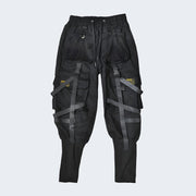 Unisex wearing black urban techwear pants adjustable straps.