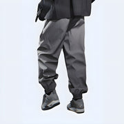 Man wearing dark grey cargo pants, back view, Techwear UK style.