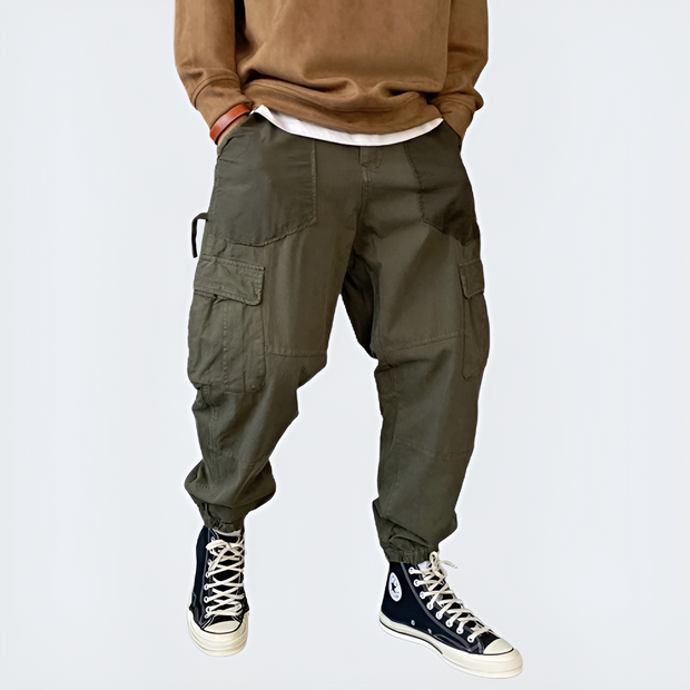 Man wearing dark green wide leg pants multiple pockets