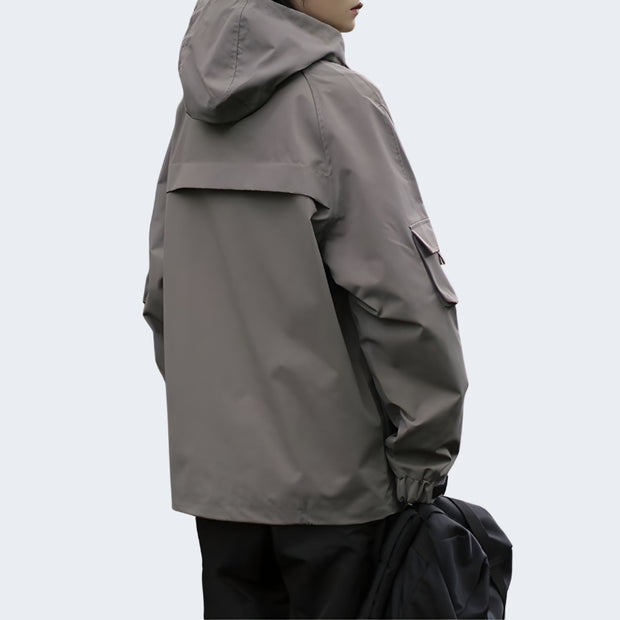 Man wearing grey techwear adjustable hood mutiple pockets