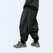 Man wearing black tactical ninja pants multiple pockets on both sides