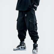 Man wearing black tactical ninja pants multiple pockets on both sides