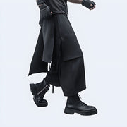 Man wearing black Techwear harem pants, side view, modern and functional streetwear from Techwear UK