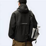 Man wearing black techwear hoodie double layered decoration