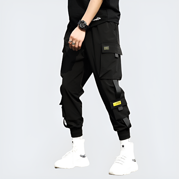 Man wearing black techwear track pants drawstring closure left side