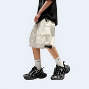 Side view of man wearing white Techwear UK shorts – lightweight tactical design with utility pockets and clean urban aesthetic.