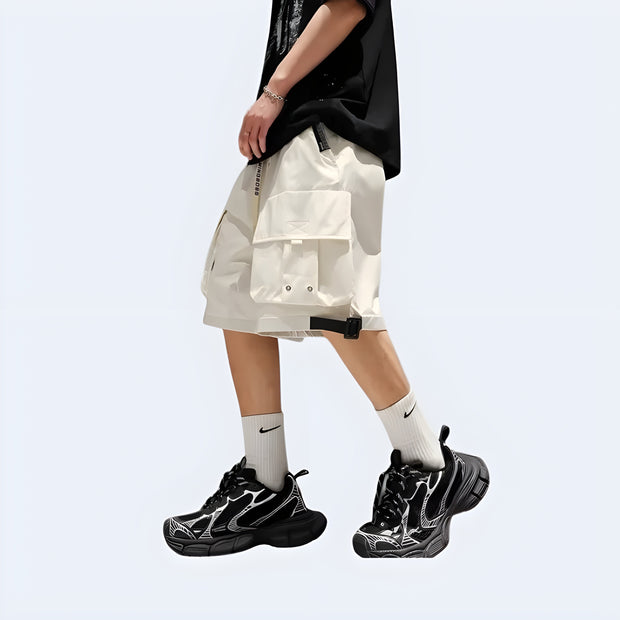 Side view of man wearing white Techwear UK shorts – lightweight tactical design with utility pockets and clean urban aesthetic.