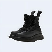 Pair of black Techwear UK boots – men’s streetwear footwear with chunky sole, lace-up design, and futuristic urban style