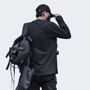 Man wearing black techwear long sleeve zip up shirt a round glue