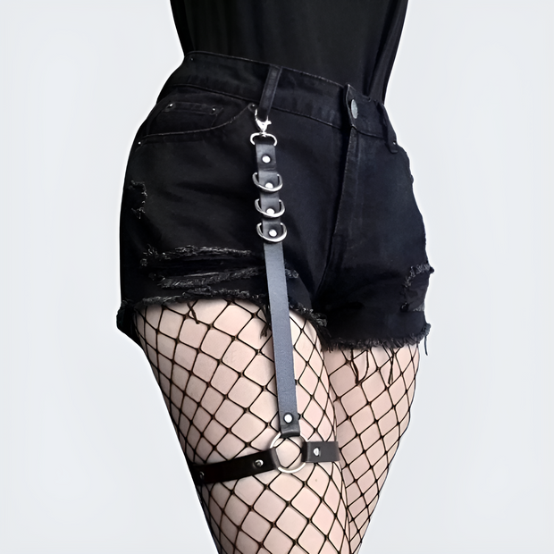 Women wearing black goth style leg harness