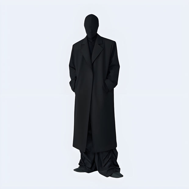 Man wearing black long techwear coat zipper closure