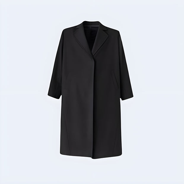 Man wearing black long techwear coat zipper closure