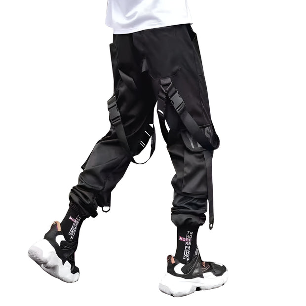 Unisex wearing black cargo joggers with straps back view
