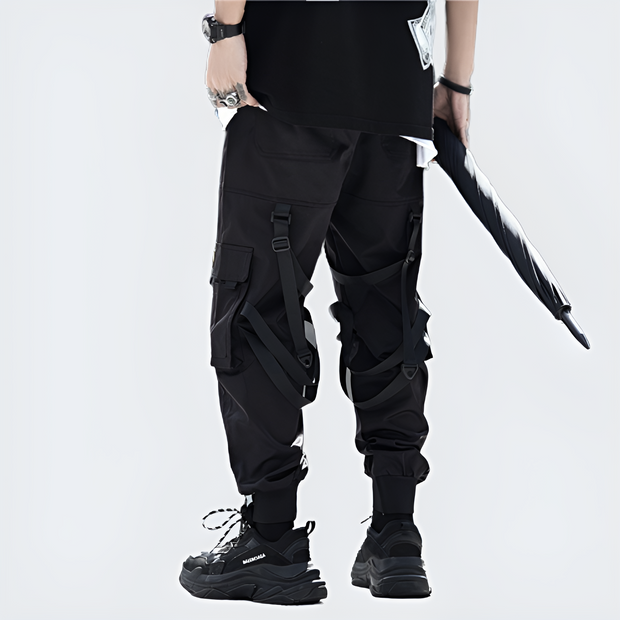 Man wearing black ninja cargo pants djustable straps