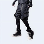 Man wearing Techwear UK hidden pocket cargo shorts back side view – tactical streetwear shorts with discreet storage, modern techwear style for urban fashion and summer functionality.