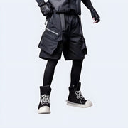 Man wearing Techwear UK hidden pocket cargo shorts front view – urban streetwear shorts with concealed storage, functional techwear design ideal for summer utility and edgy fashion looks.