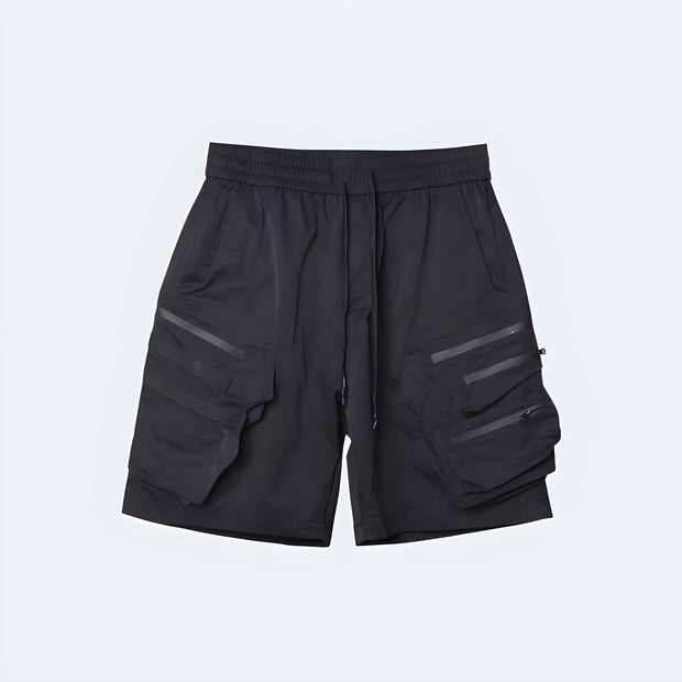 Techwear UK hidden pocket cargo shorts front view – man wearing black tactical summer shorts with hidden compartments, ideal for urban streetwear style, futuristic fashion, and everyday techwear utility.