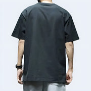 Man wearing Techwear UK reflective pocket T-shirt – back view highlighting 3M reflective elements, functional design, and modern urban techwear aesthetic.