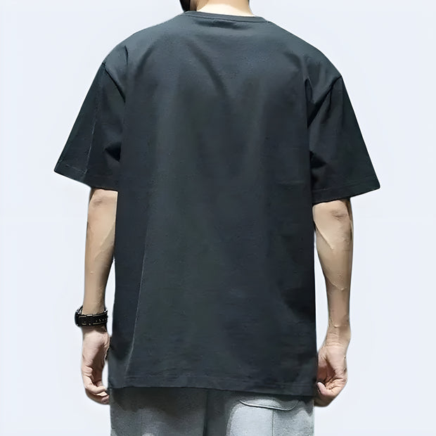Man wearing Techwear UK reflective pocket T-shirt – back view highlighting 3M reflective elements, functional design, and modern urban techwear aesthetic.