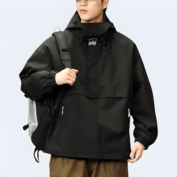 Wearing black Techwear hoodie, front and side view, sleek urban streetwear style, available in the UK