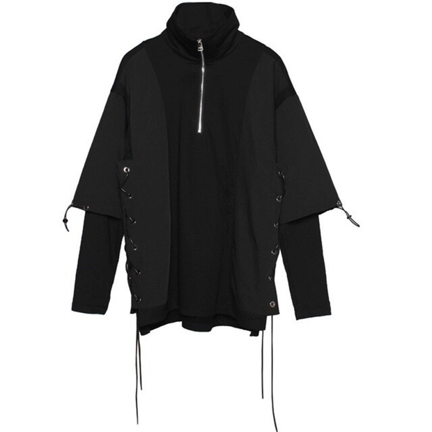 Unisex wearing black deconstructed sweater