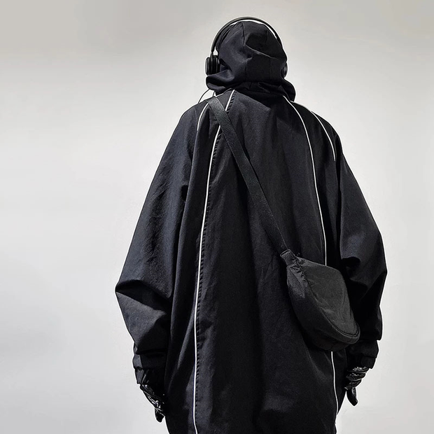Man wearing black tactical poncho hoodie multiple pockets decoration