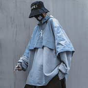 Man wearing blue techwear hoodie adjustable hood