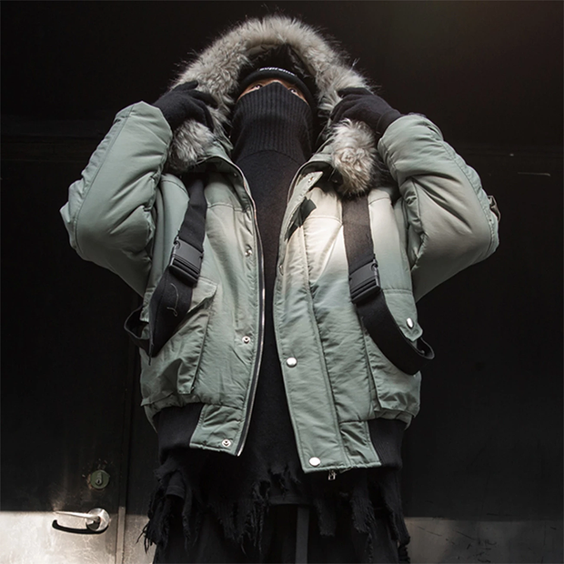 Man wearing green bybb winter parka ribbons and feathers decoration