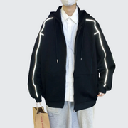 Man wearing black hoodie with reflective stripes zipper closure