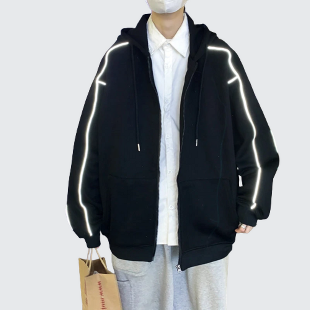 Man wearing black hoodie with reflective stripes zipper closure