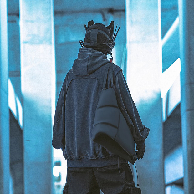 Man wearing navy blue cyberpunk techwear hoodie patchwork style