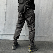 Back view man wearing black paratrooper cargo pants adjustable straps