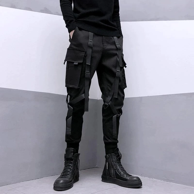 Man wearing black cyberpunk cargo pants multiple pockets on both sides