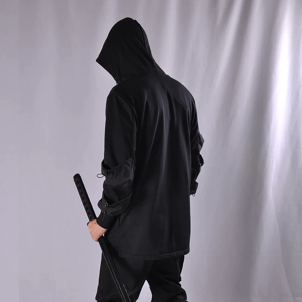 Man wearing black techwear hoodie black ninja style hoodie